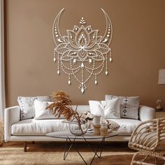 a living room filled with furniture and a large metal wall art hanging on the wall