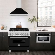 a stove top oven sitting inside of a kitchen next to a window and counter tops