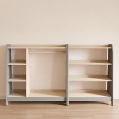 an empty shelf with two open shelving units on the bottom, and one closed