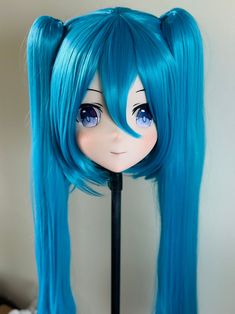 a doll with long blue hair and big eyes