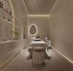 a spa room with a white table and round mirror