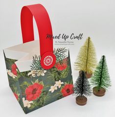 two small christmas trees are next to an ornament and gift bag with the word made up craft on it