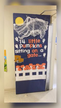 a door decorated with pumpkins and writing on it