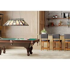 a pool table and some chairs in a room