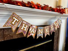 a thanksgiving banner hanging from a fireplace mantel