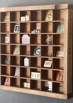 a wooden shelf filled with lots of different types of magnets on it's sides