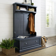 an entryway with a bench and coat rack