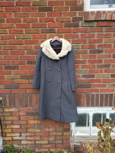 Up for sale is a vintage 1950's to 1960's Mink Collar Wool long jacket in an elegant style, estimated size Medium to Large. This coat is amazing! It is heavy and incredibly stylish. It does have some stains on it, primarily the larger one near the bottom of the coat. I am unsure if it would wash / scrub / dry clean out. Despite this, it is truly a beauty. It does have some various flaws in the knit, such as pulled threads, but no rips or tears. Estimated size: Women's M to L Wool and mink Measured flat: Inches in Length: 41 Inches Pit to pit: 20 Inches Shoulder to Shoulder: 17 Inches cuff to shoulder: 23 Elegant Coats, Long Jacket, Vintage 1950s, Clean Out, Elegant Style, 1960s, Jackets & Coats, Dry Clean, Jackets For Women