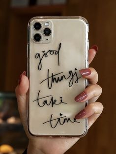 a woman holding up a phone case with writing on it that says good things are fine