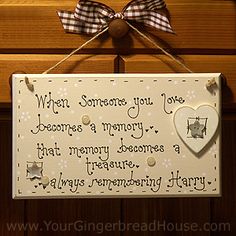 a wooden sign hanging from the side of a wall with a bow on it that says when someone you love becomes a memory, that memory