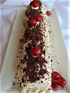 a piece of cake with cherries and chocolate shavings