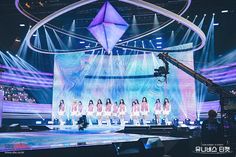 a group of women standing on top of a stage