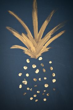 a golden pineapple on a dark blue background with gold foiled spots in the middle