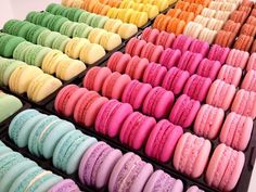 there are many different colored macaroons in the tray