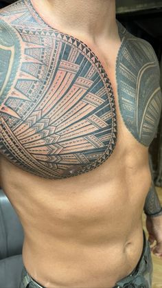 a man with a large tattoo on his chest