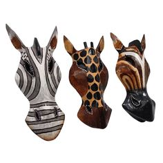 three zebra head sculptures are shown against a white background