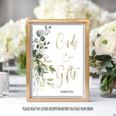 wedding card and gifts sign with white flowers in vases on the table next to it