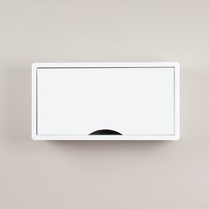 a white wall mounted light switch with a black button on the left side and a grey background