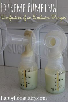 two baby bottles filled with liquid sitting next to each other