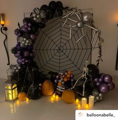 a halloween decoration with candles and decorations on the table in front of a spider web