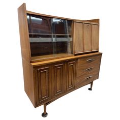 a wooden cabinet with glass doors and drawers