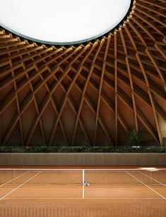 a tennis court with a large wooden structure on top