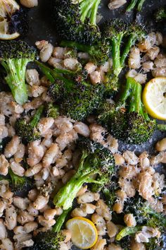 broccoli and chickpeas stir fry with lemon slices on the side in a skillet