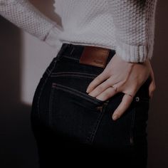 a woman with her hand in the pocket of her jeans