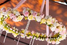 an arrangement of flowers hanging from the ceiling