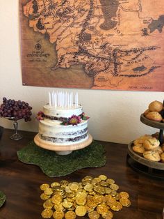 a table topped with cakes and pastries next to a map