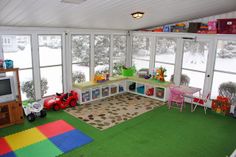 a child's playroom with lots of windows and toys