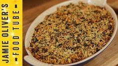 a casserole dish filled with lots of food on top of a wooden table