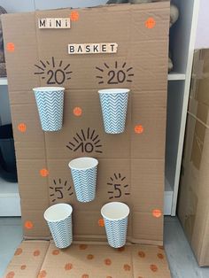 a cardboard box with cups in it and numbers on the side