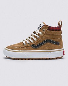 You are Made For The Elements. These are your Vans. The Sk8-Hi is an all-time Vans classic, but the Kids Sk8-Hi MTE-1 is built for adventure with a water-resistant suede upper, a Primaloft insulation package, and an outsole that’s been designed for increased traction. Classic style and protection from the elements. That’s what MTE is all about. MOISTURE MANAGEMENT - A water-resistant upper provides a splash and puddle guard around the shoe and over the toe, resulting in reliable, comfortable, breathable moisture management protection. THERMOREGULATION - The zonal MTE™-1 Primaloft® insulation package uses a high-quality microfiber thermal insulation system to mimic the warmth-providing properties of down, keeping you warm without retaining internal moisture. TRACTION - MTE™-1’s lugged outso Brown Plaid Vans, Plaid Brown, Vans Store, Vans Kids, Vans Logo, School Clothes, Boys Sneakers, Sk8 Hi, Crib Shoes