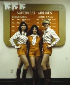 three women in short shorts and ties standing next to each other