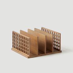 three wooden bookshelves sitting on top of each other