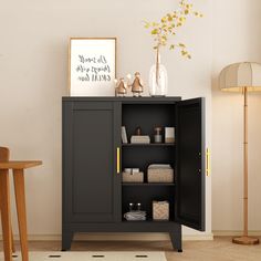 a black cabinet with some items on top of it and a lamp next to it