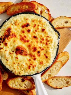 cheese dip in a skillet surrounded by slices of bread