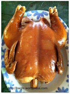 a close up of a plate with a chicken on it's back and legs