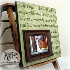 a wooden frame with a wedding photo on it and the words to our parents - our wedding is not only a celebration of our love, but of your love