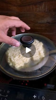 someone is frying some food in a pan on top of an electric burner