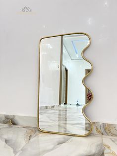 a large mirror sitting on top of a marble counter