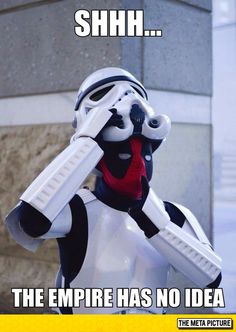 a star wars action figure is posed in front of a building with his hand on his face