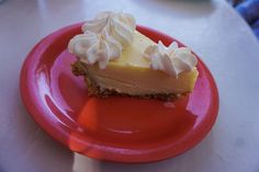 a piece of pie sitting on top of a red plate