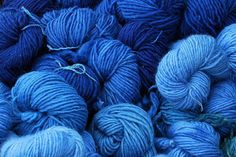 many skeins of blue yarn are piled together