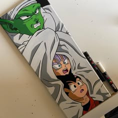 an image of cartoon characters on a notebook with marker and pen next to it,