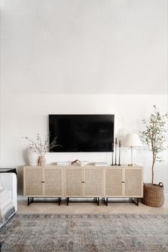 a living room with a large flat screen tv on the wall