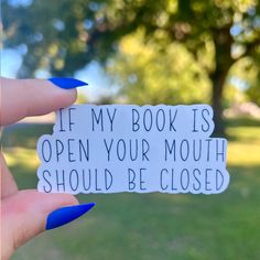 a person holding up a sign that says if my book is open your mouth should be closed