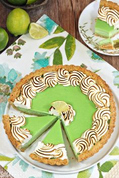 there is a pie on the table with limes around it