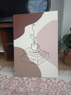 there is a card with a cup on it and a clock in the back ground